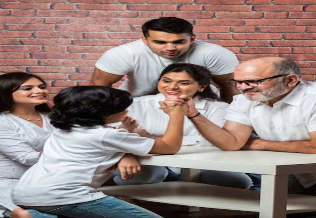 shortplayful-indian-asian-kid-grandfather-arm-wrestling-home-with-other-family-members-looking-wearing-white-cloths_466689-3463.jpg